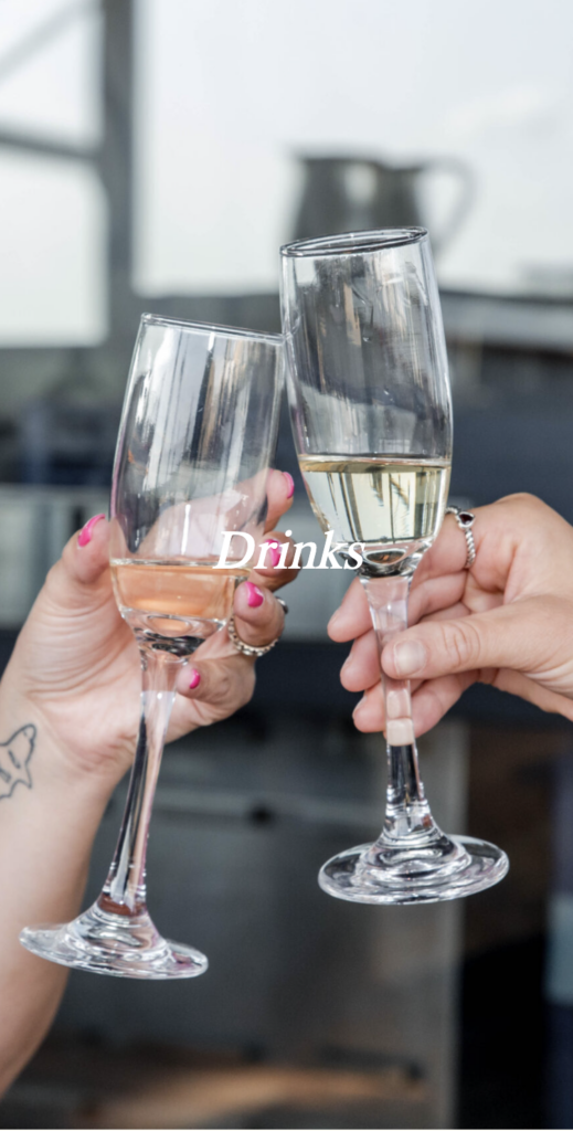 Two hands clinking champagne glasses together